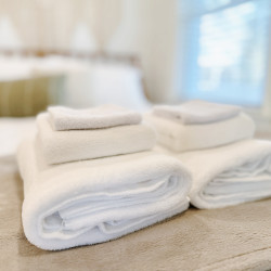 Bath towels are provided in the room, allowing both guests to dry off and feel comfortable after taking a refreshing shower