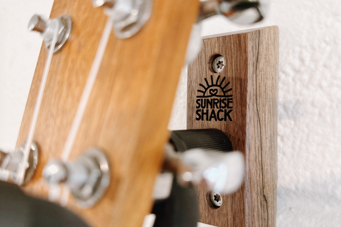 The Sunrise Shack stand on the wall helps to display one of our all time favorite instruments, the ukulele, adding a touch of charm and personality to the space