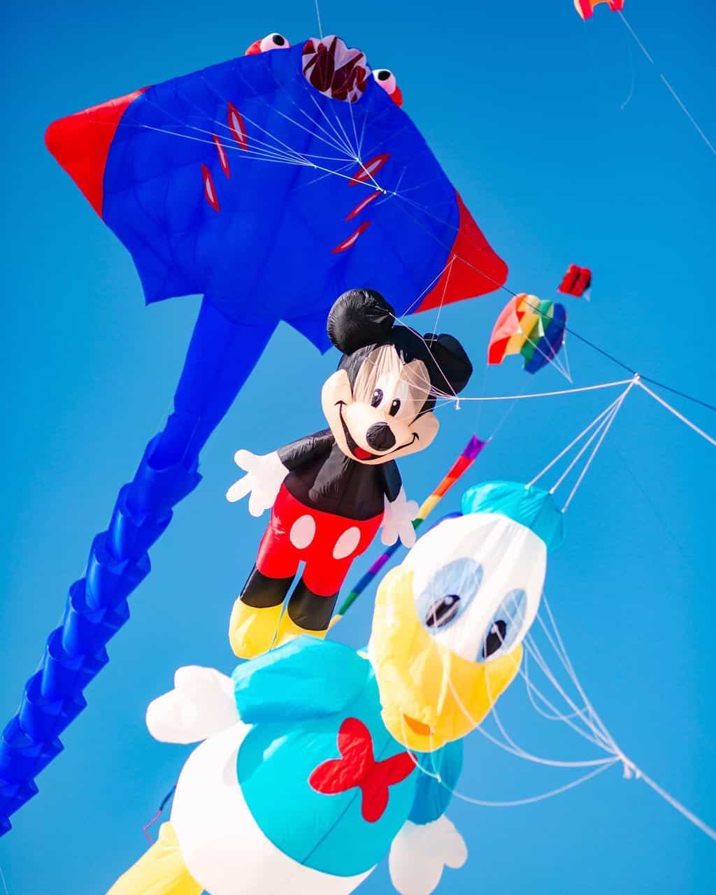 Mickey Mouse and Donald Duck kites flying in the 2023 Cape Fear Kite Festival in Fort Fisher, NC